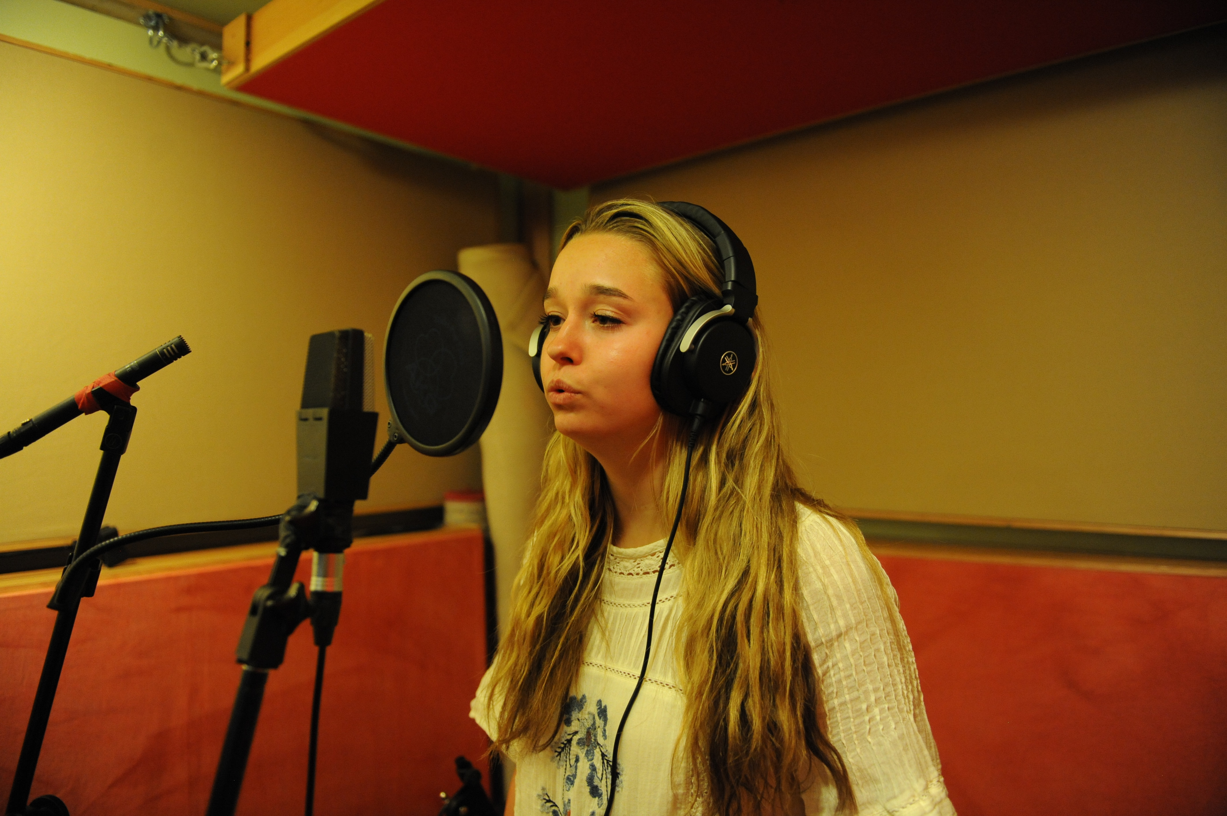 Teen female singing and recording.